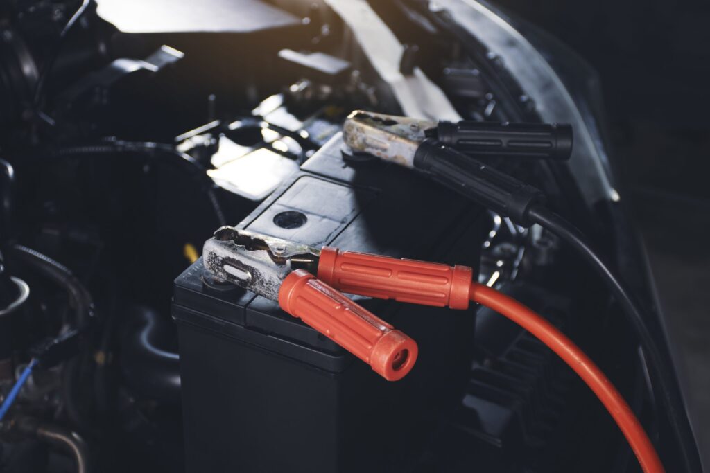 The charging cable is securely fastened to the car battery.